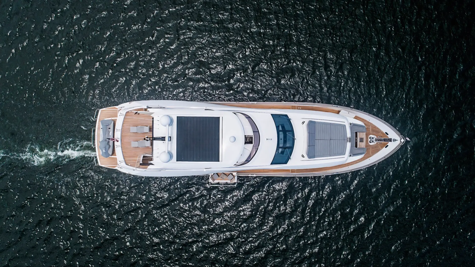 Aerial view of Sunseeker 95 yacht at sea, highlighting its spacious deck layout.