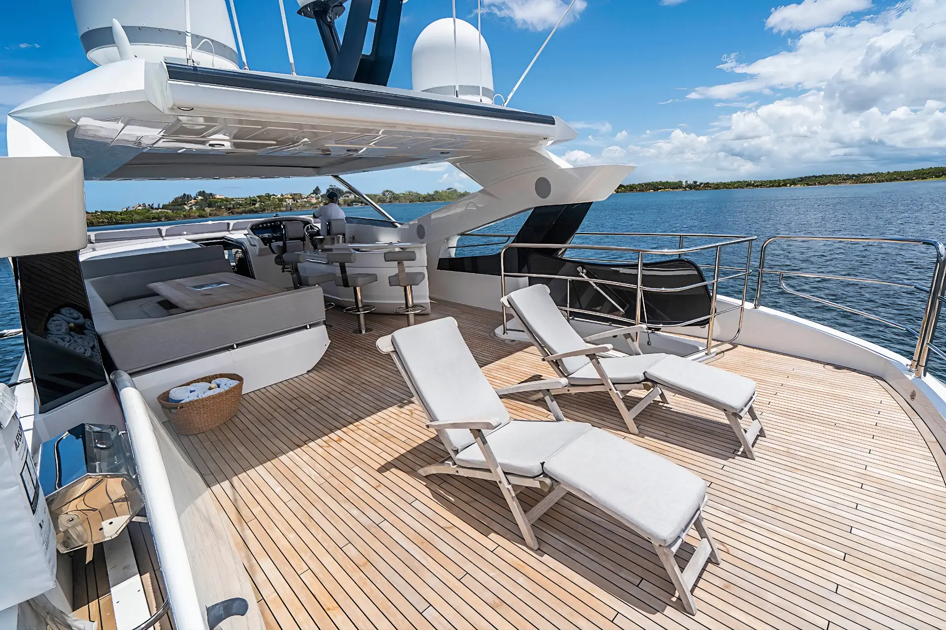 Sunbeds on Sunseeker 95 flybridge offering ultimate relaxation and sea views.