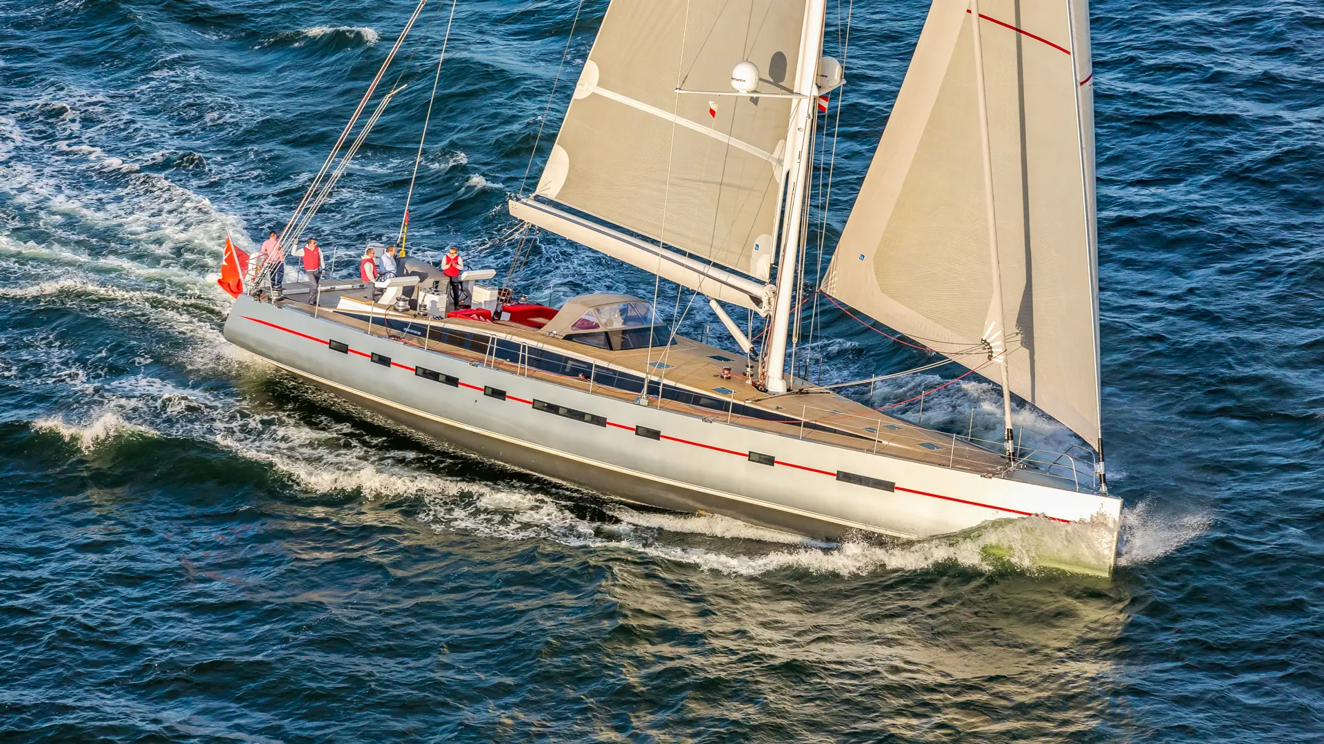 Luxury sailing yacht Bellkara - full sails up, side view gliding across the water with effortless sophistication.