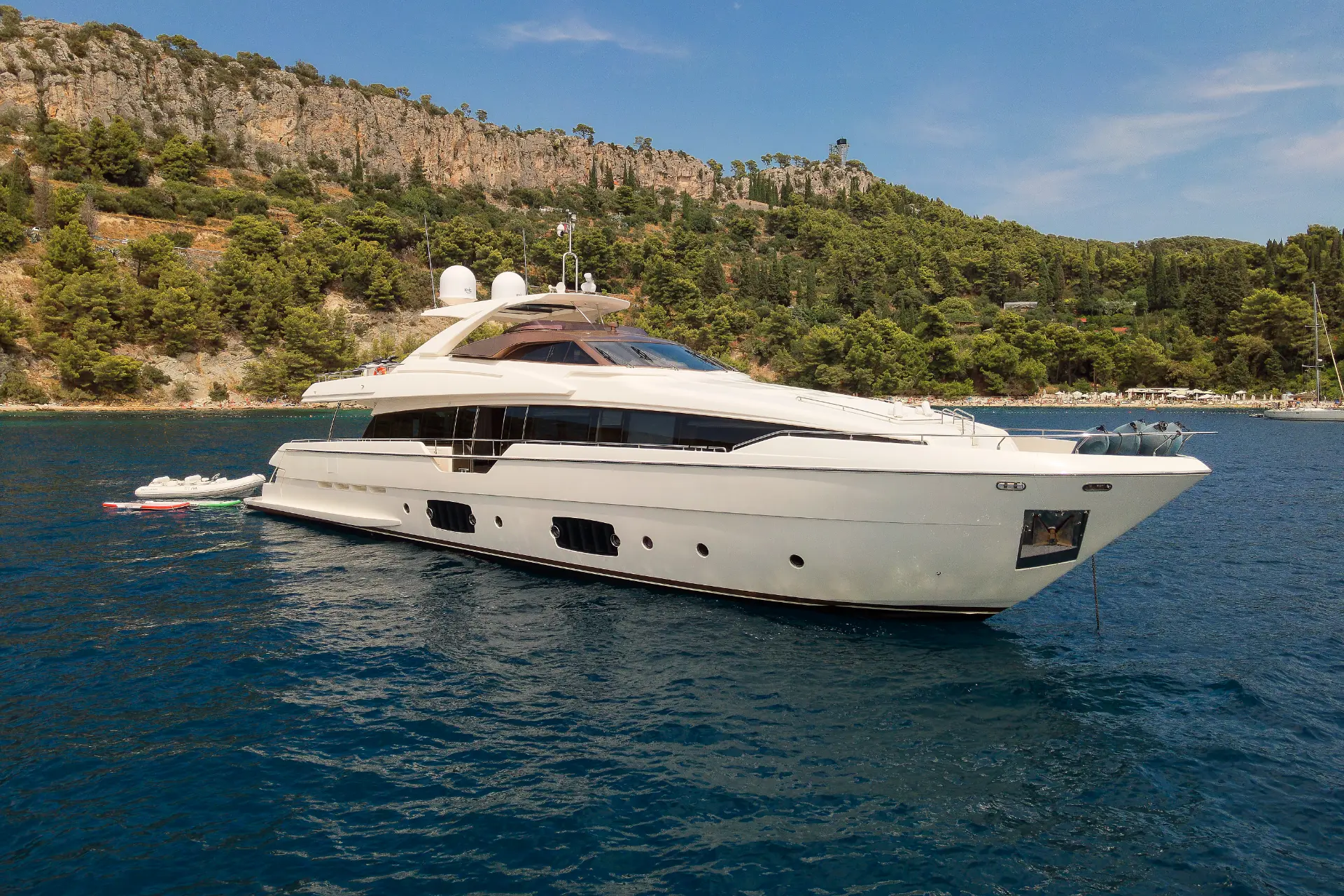 Luxury Motor Yacht Ferretti 960 – anchored in scenic bay, surrounded by greenery and peaceful coastal landscape.