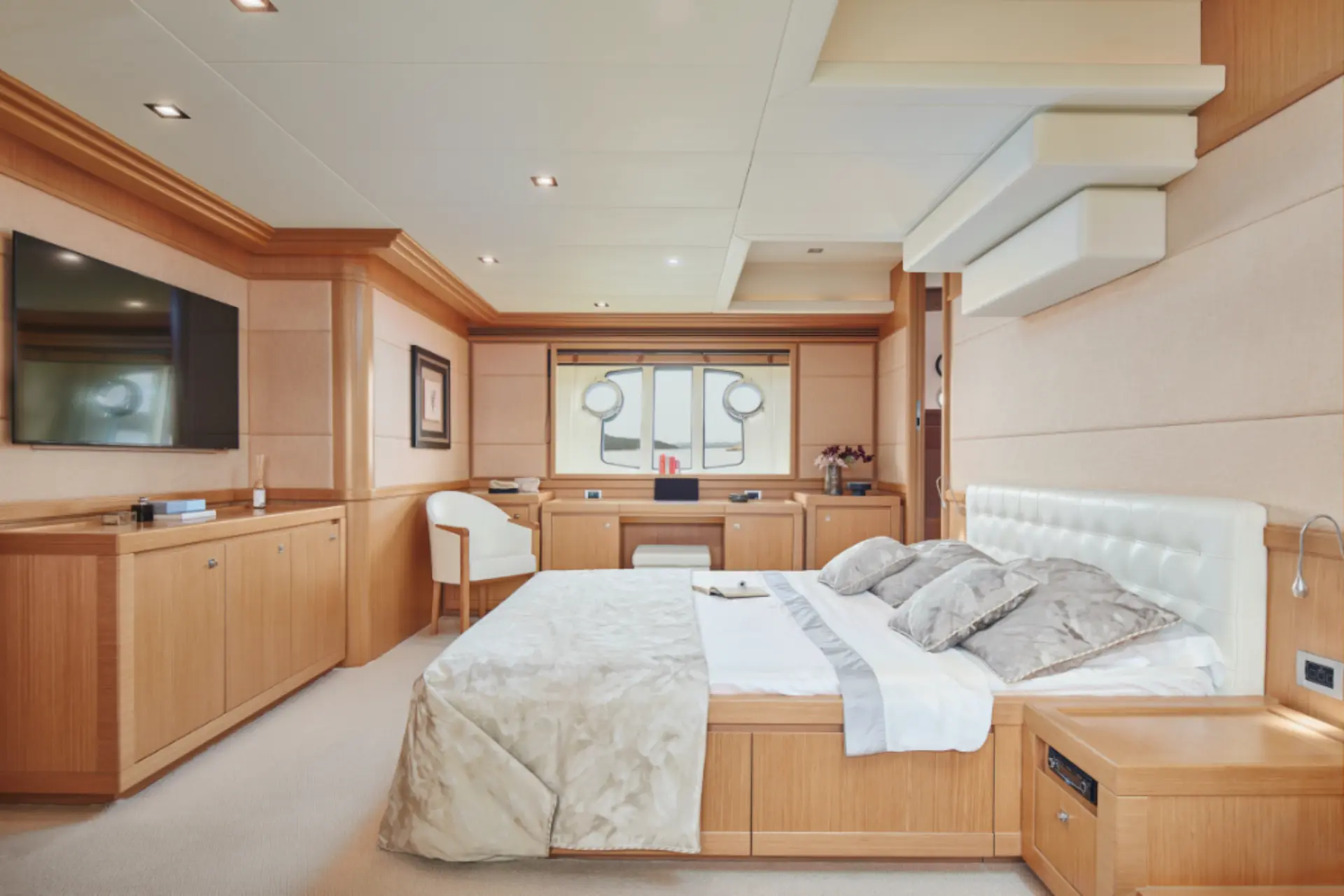 Friend’s Boat – luxurious master cabin with a sleek desk and flat TV, perfect for relaxation.