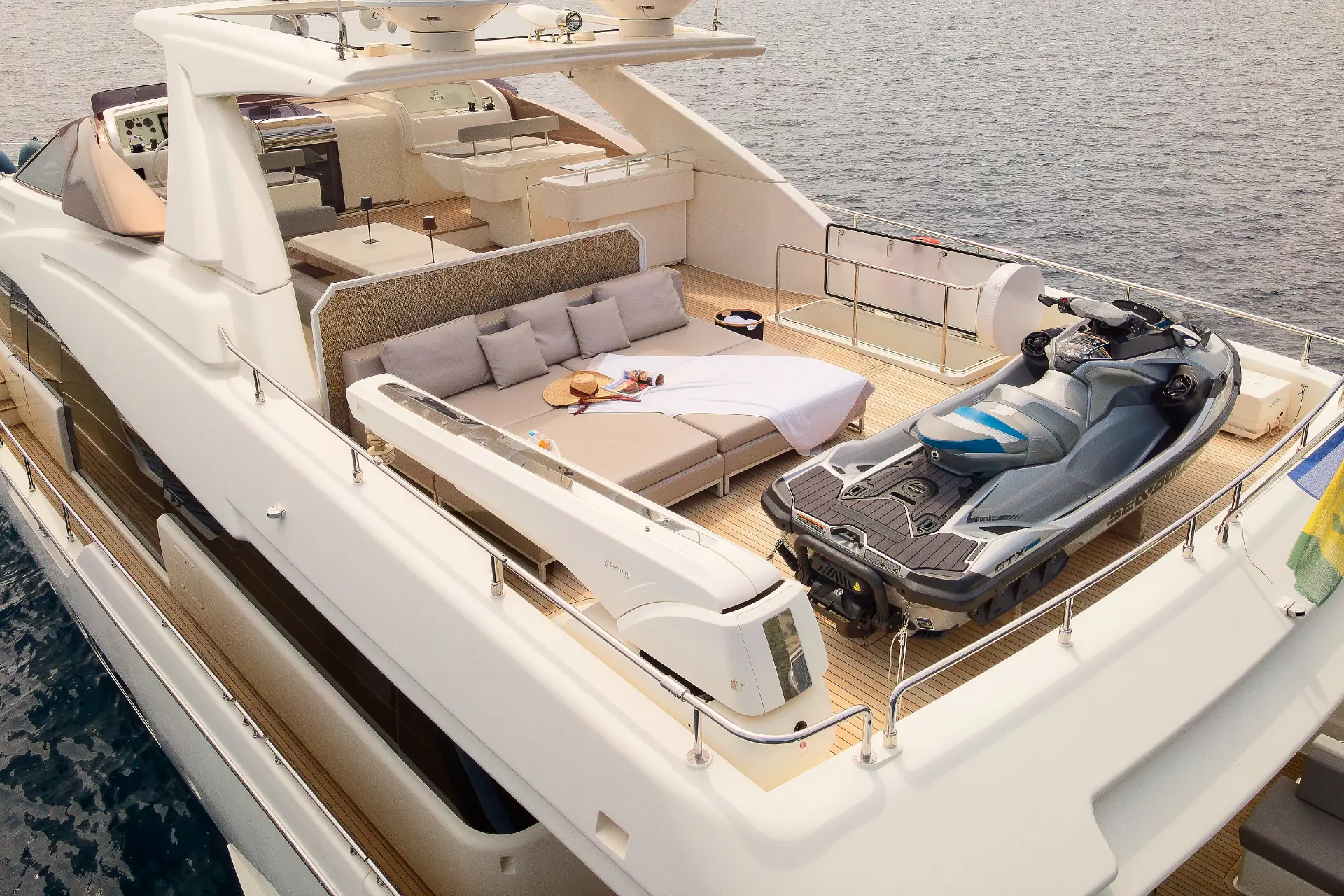 Iva – flybridge seen from above, aft to bow angle with sunpads tender and jet ski in front.