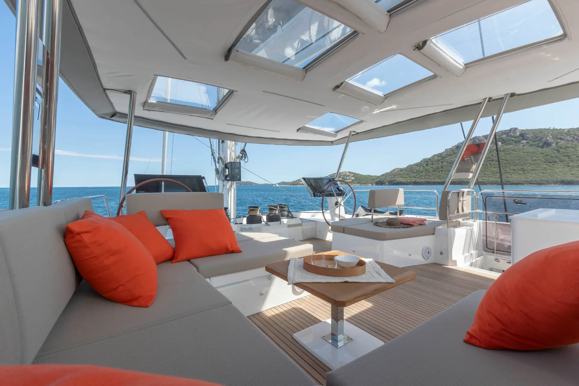 FLORAMYE – shaded flybridge, view forward with comfy lounge and helm station in sight.
