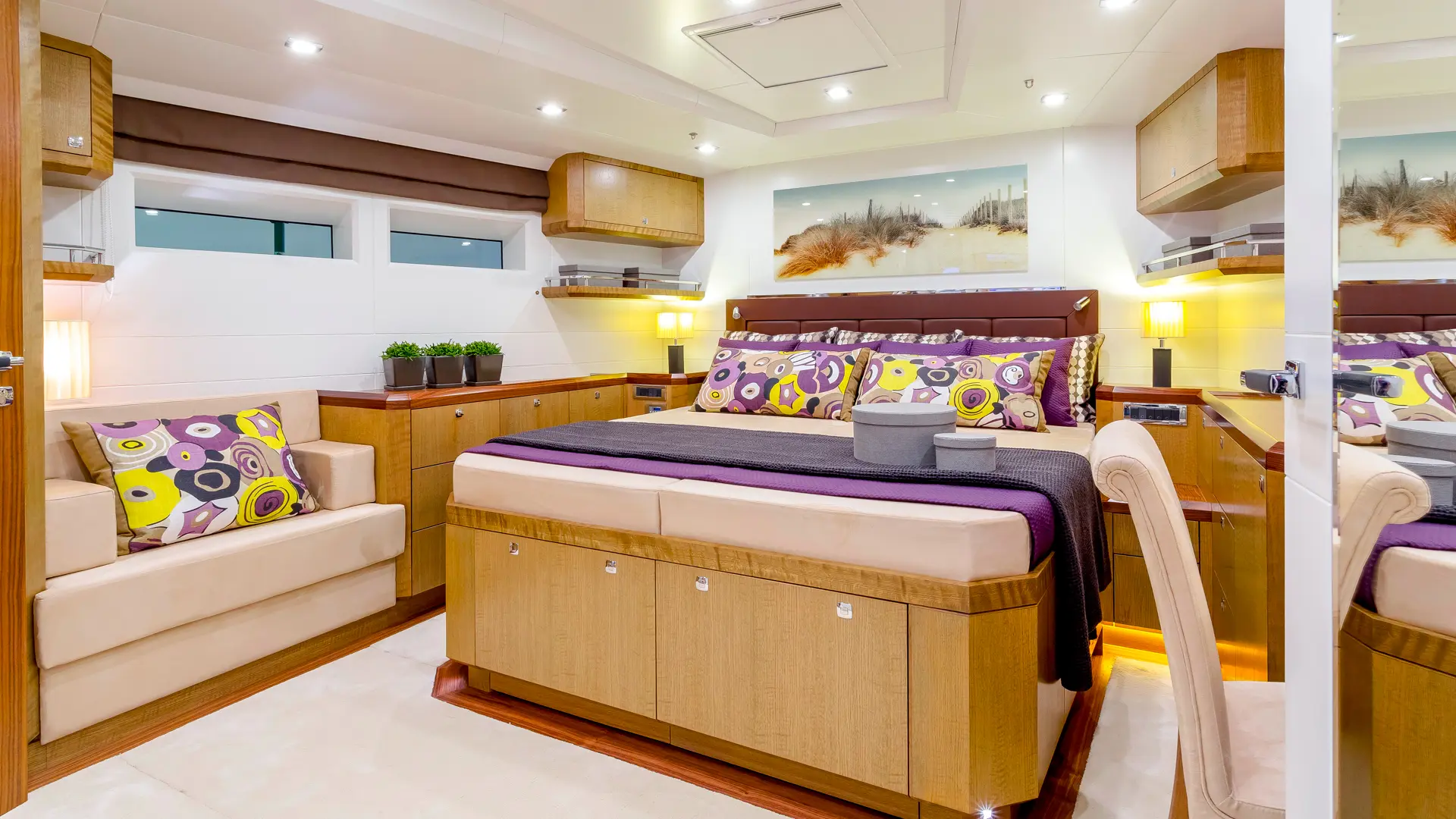 Bellkara - stylish suite with center bed, work desk on the right, cozy couch left, in muted lilac, white, and coffee colors.