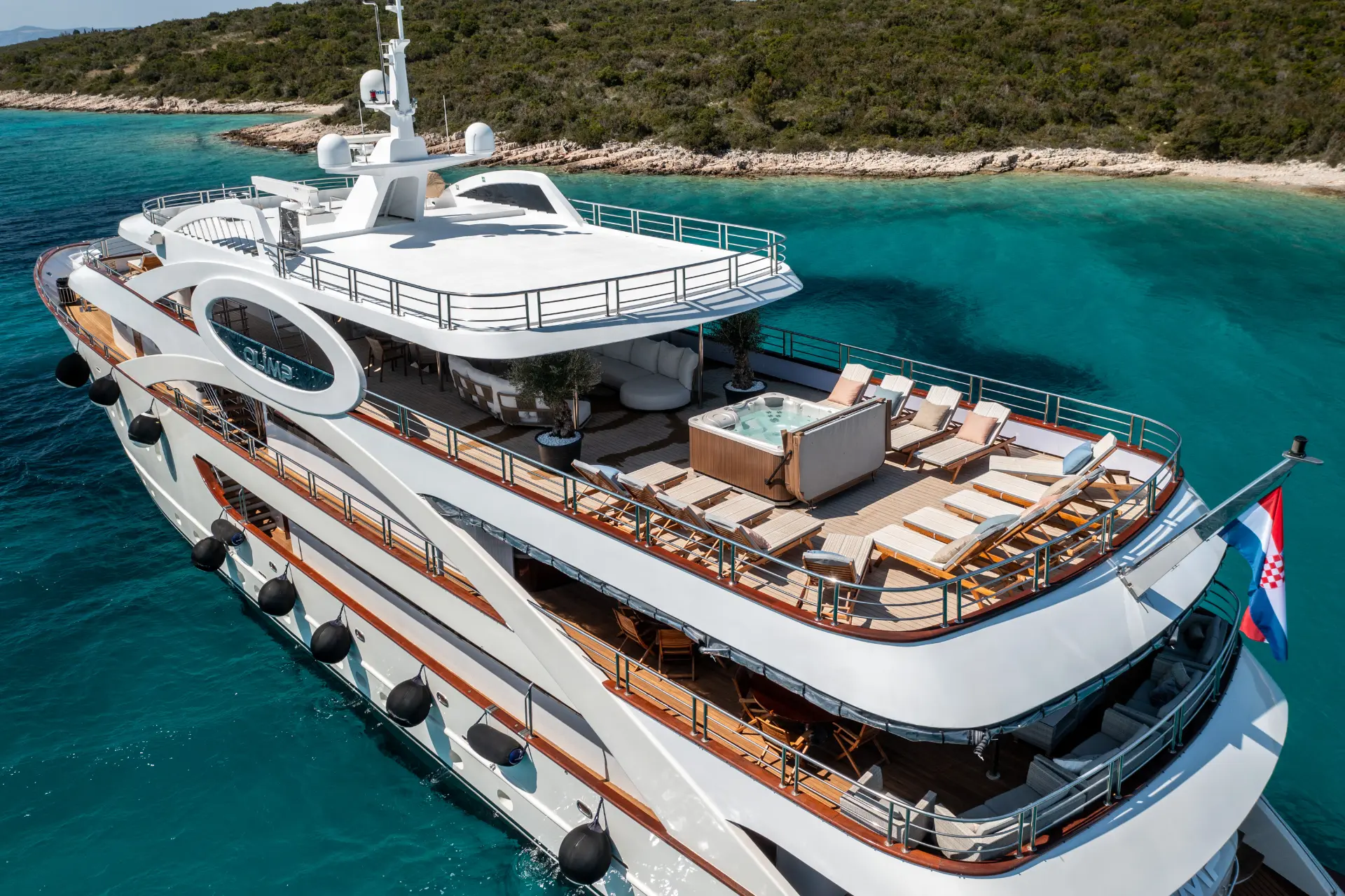 Olimp - close aft aerial view, highlighting Jacuzzi and loungers on spacious upper deck