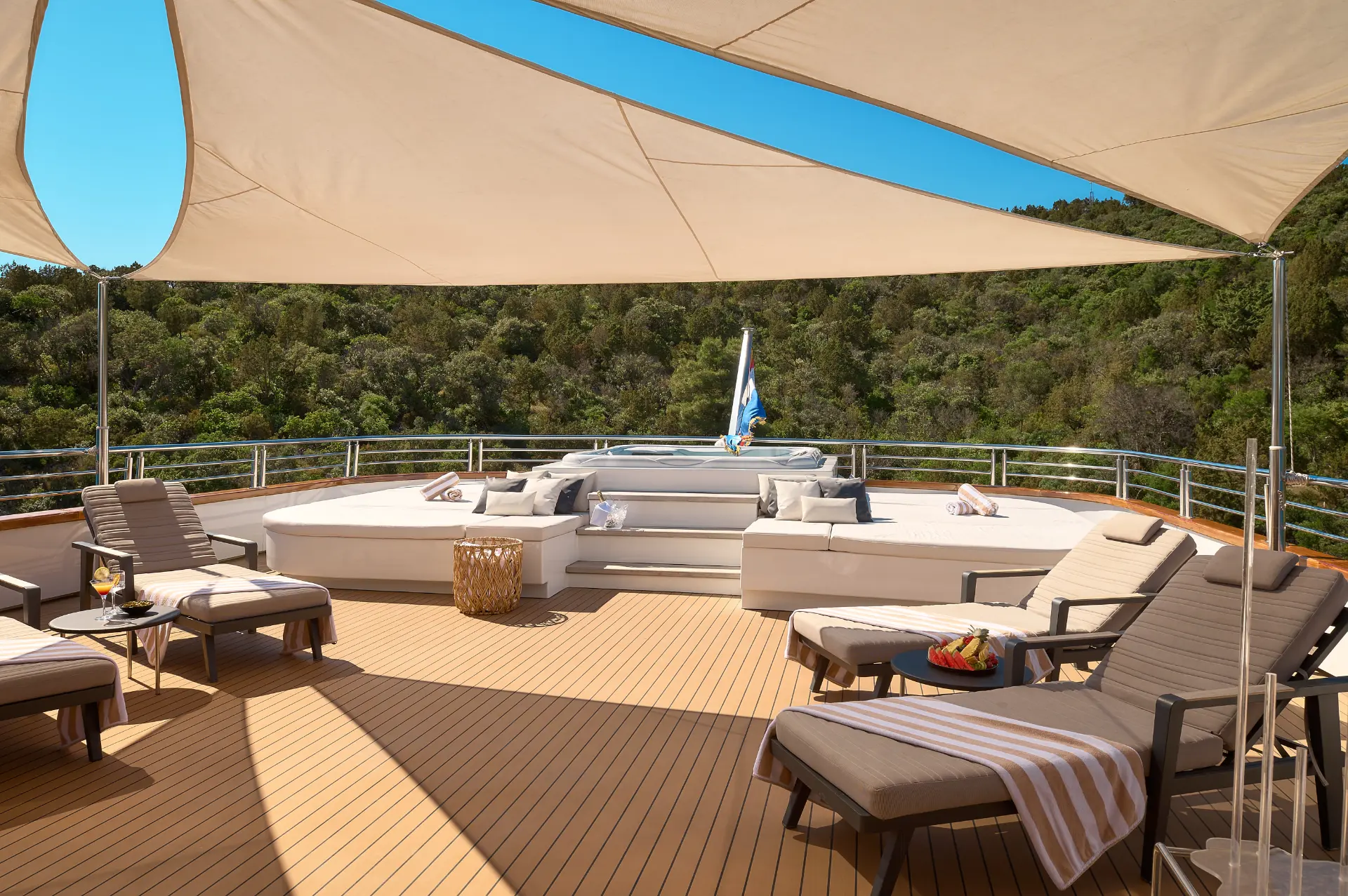 Cristal - relaxing sundeck setup with teak deck, jacuzzi, loungers, shaded tenda, and cozy tables