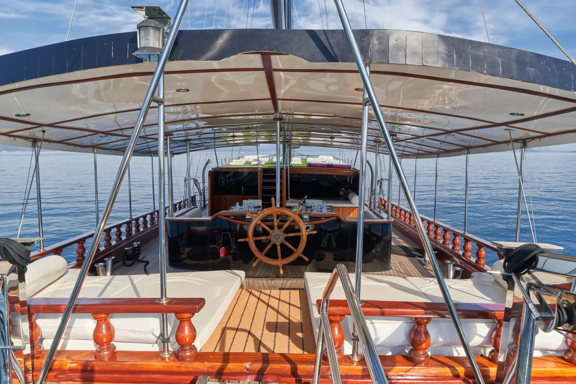 Stella Maris – close view of aft cockpit, view towards bow, showing elegant sunbed area and alfresco dining setup.