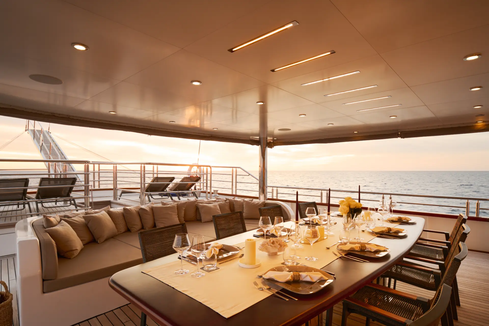 Love Story yacht aft deck, elegant dining setup with sea view towards the stern, ready for al fresco meal.