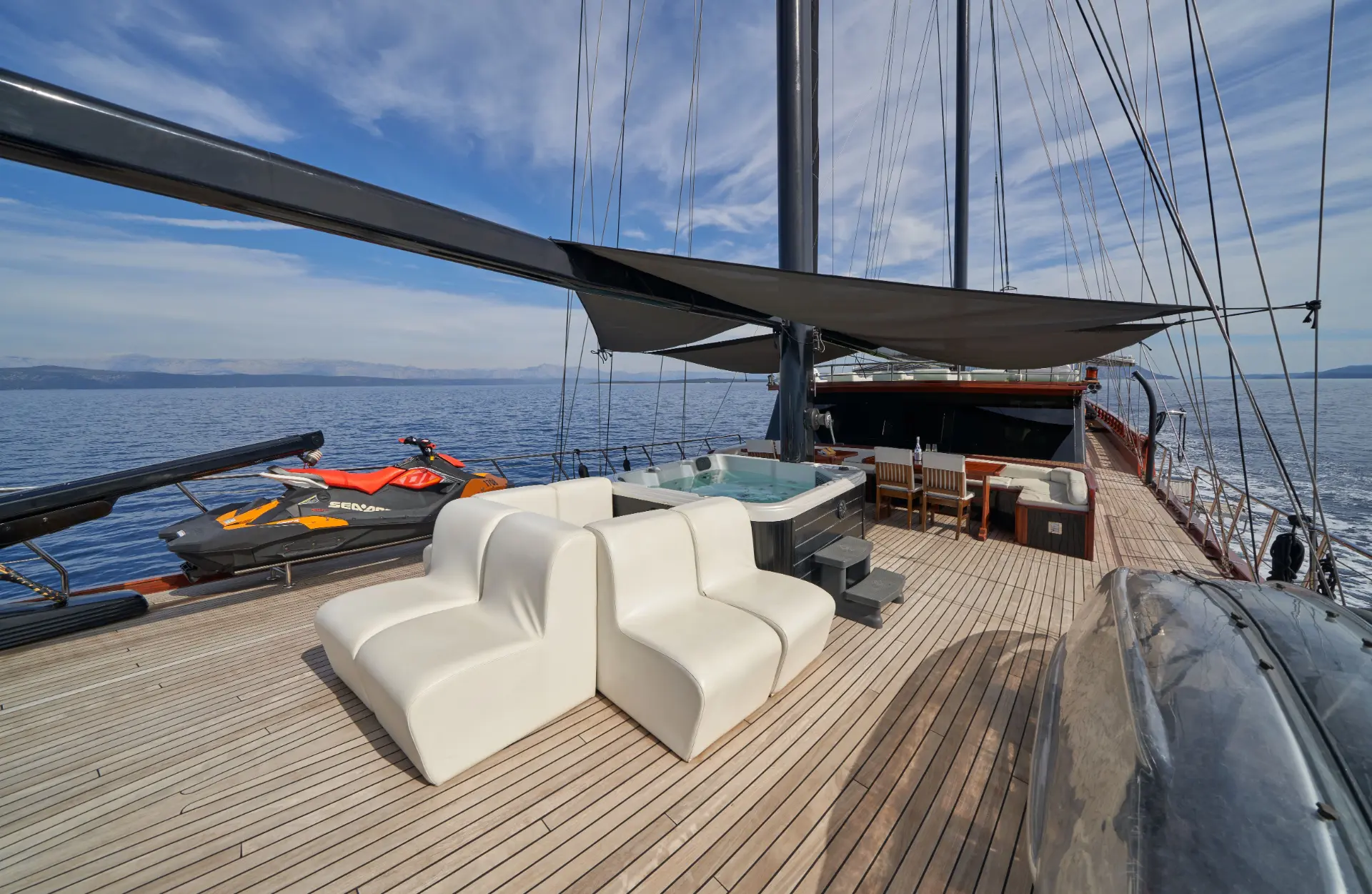 Stella Maris – foredeck, view towards the bow, with alfresco dining, jacuzzi, and relaxing seating space.