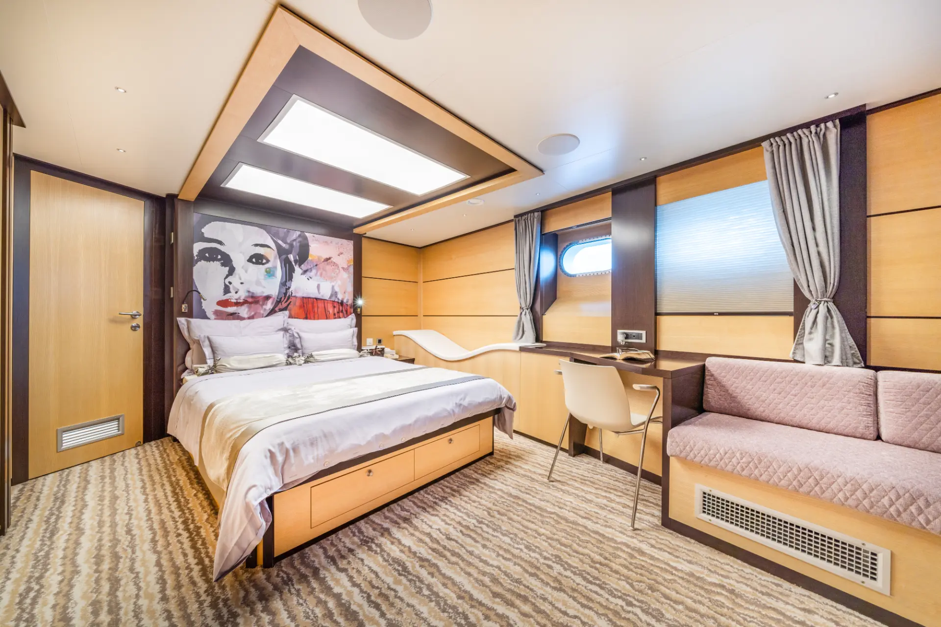 Navilux: master bedroom with comfortable double bed, desk area, seating, and large framed picture above bed.