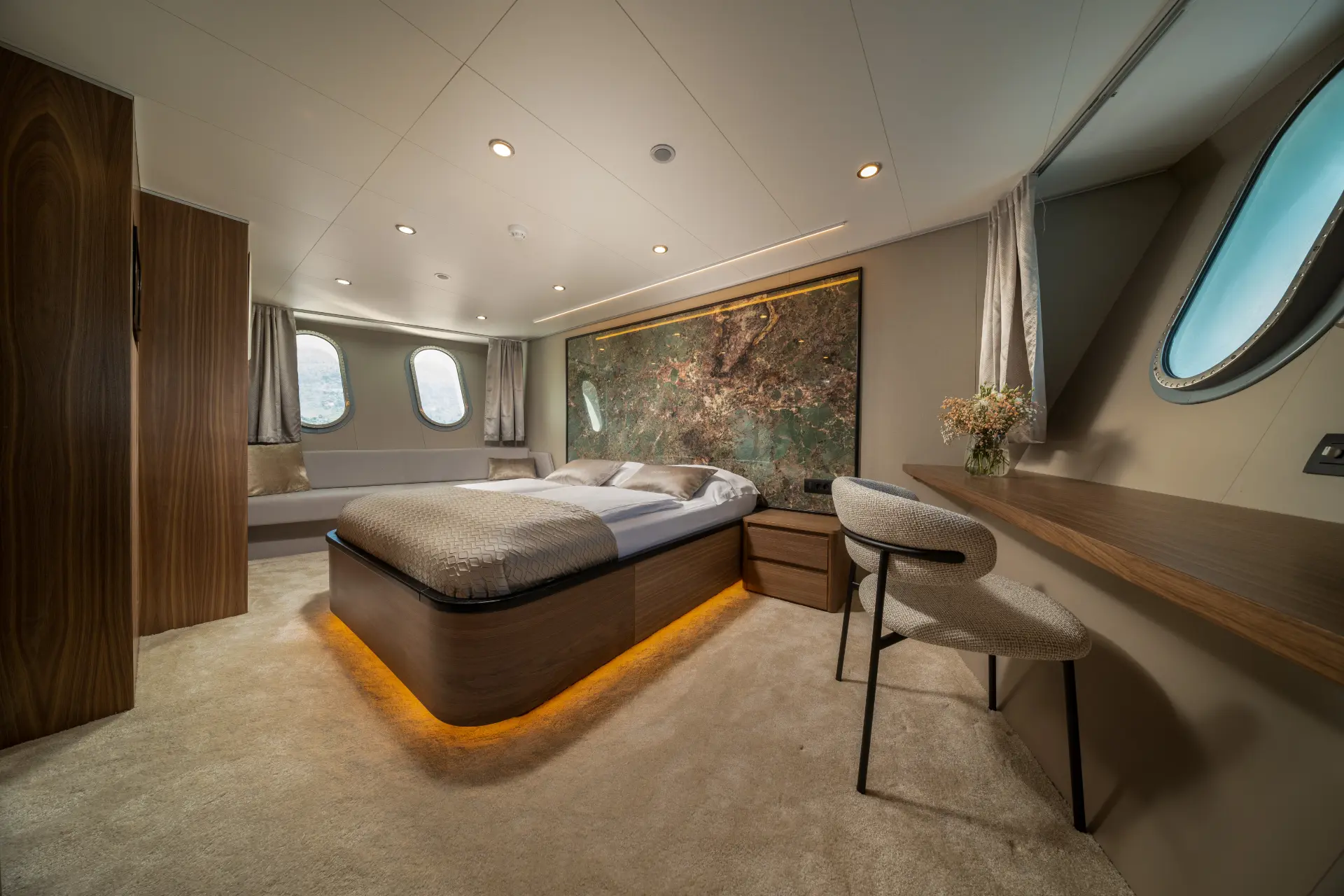 Olimp - elegant master bedroom with cream carpet flooring, double bed, cozy seating, and desk