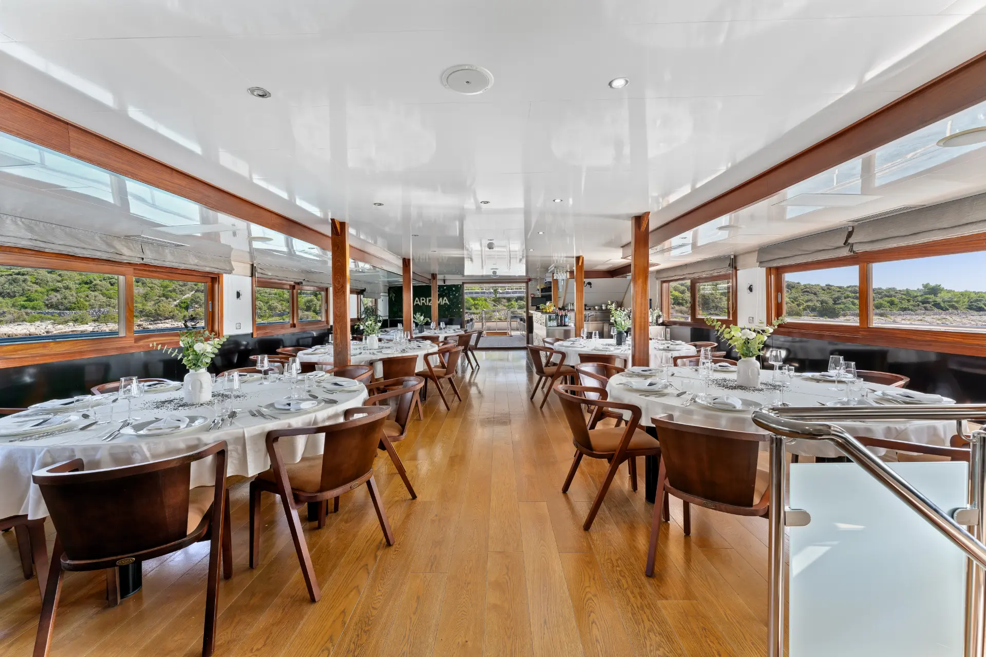 Karizma – indoor dining room showing multiple tables, view toward the entrance door.