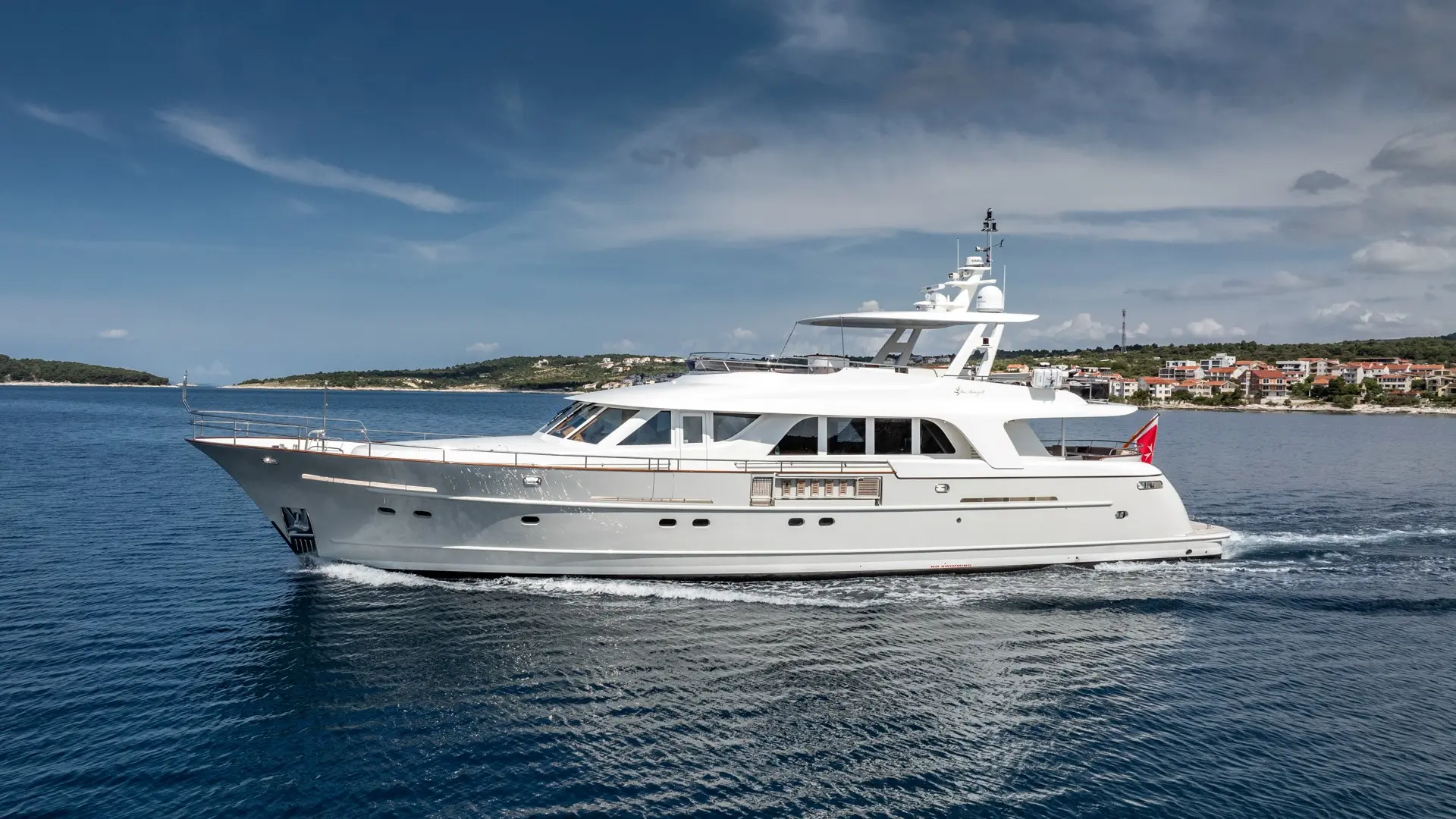 Luxury motor yacht Sea Breeze II – CRUISING, side view, stylish profile cutting through waves on the Adriatic Sea
