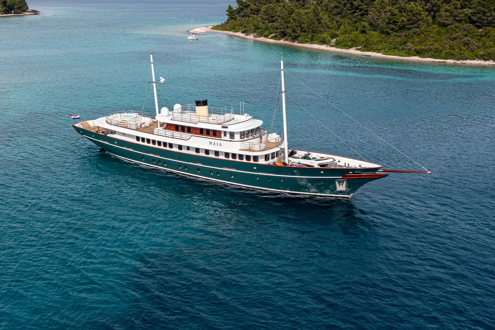 Luxury motor yacht Maia - aerial side view anchored near small islet in Korčula archipelago
