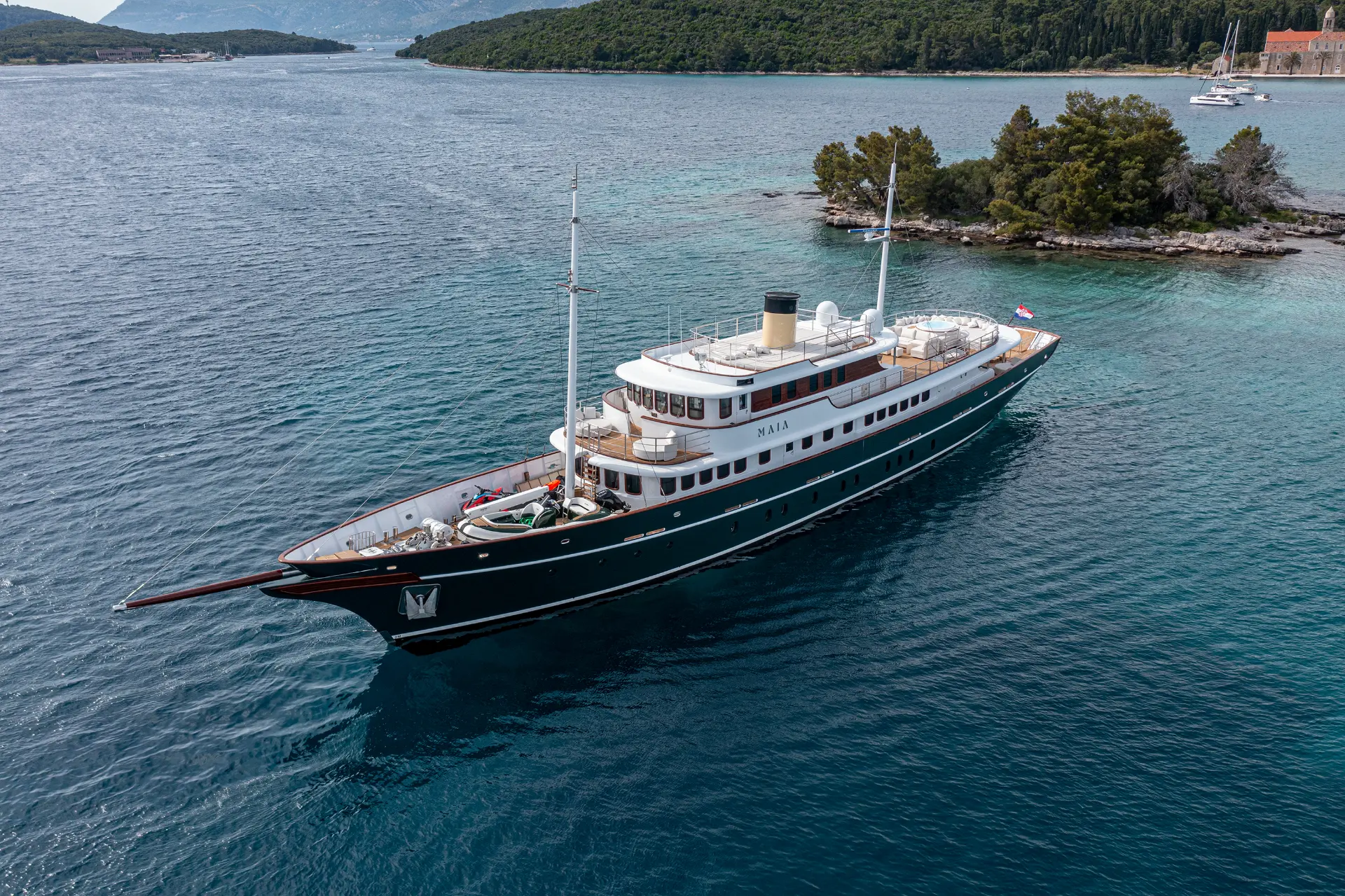 Luxury motor yacht Maia - side aerial shot in turquoise waters of Korčula islet