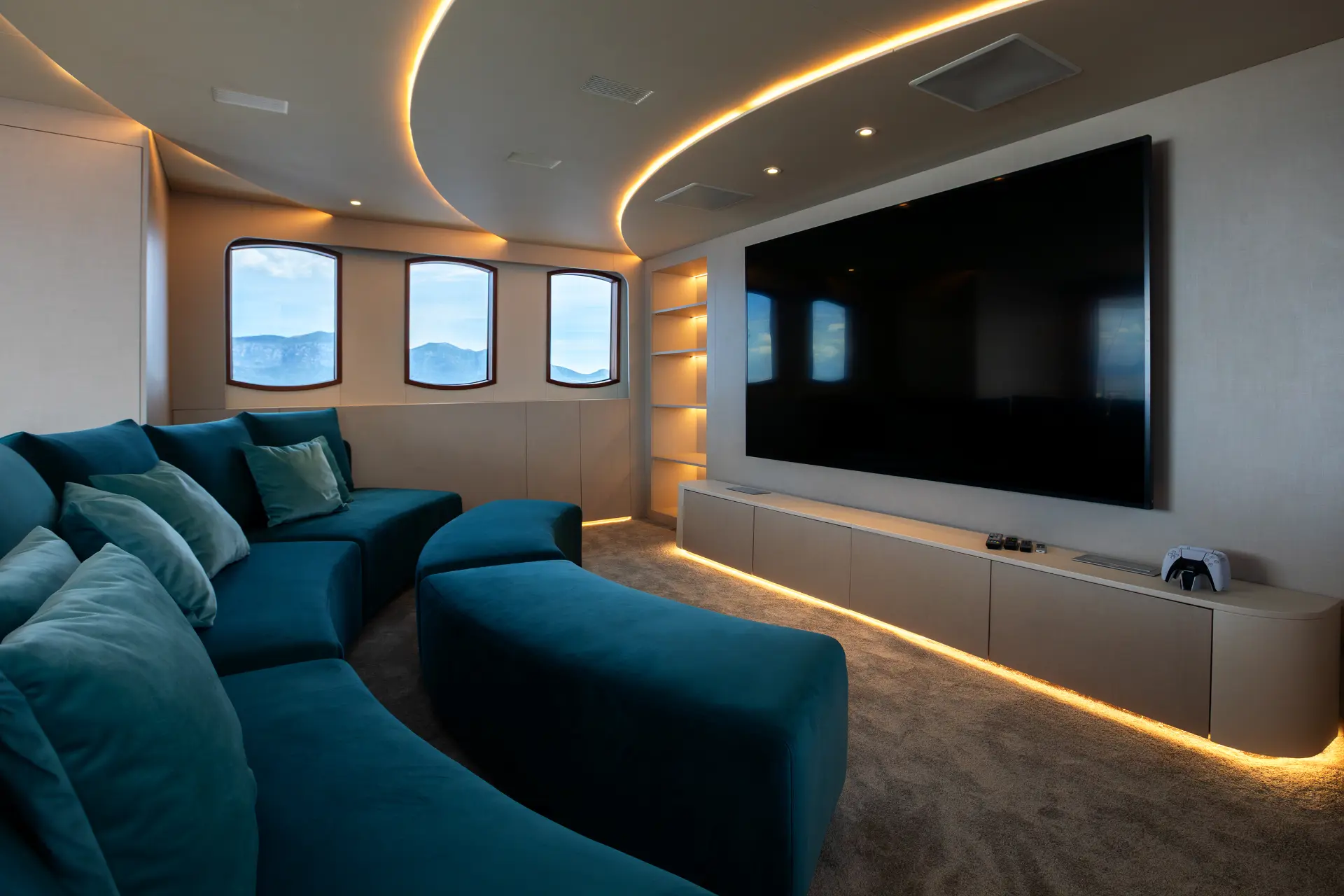 Maia - onboard cinema featuring plush blue seating and big screen