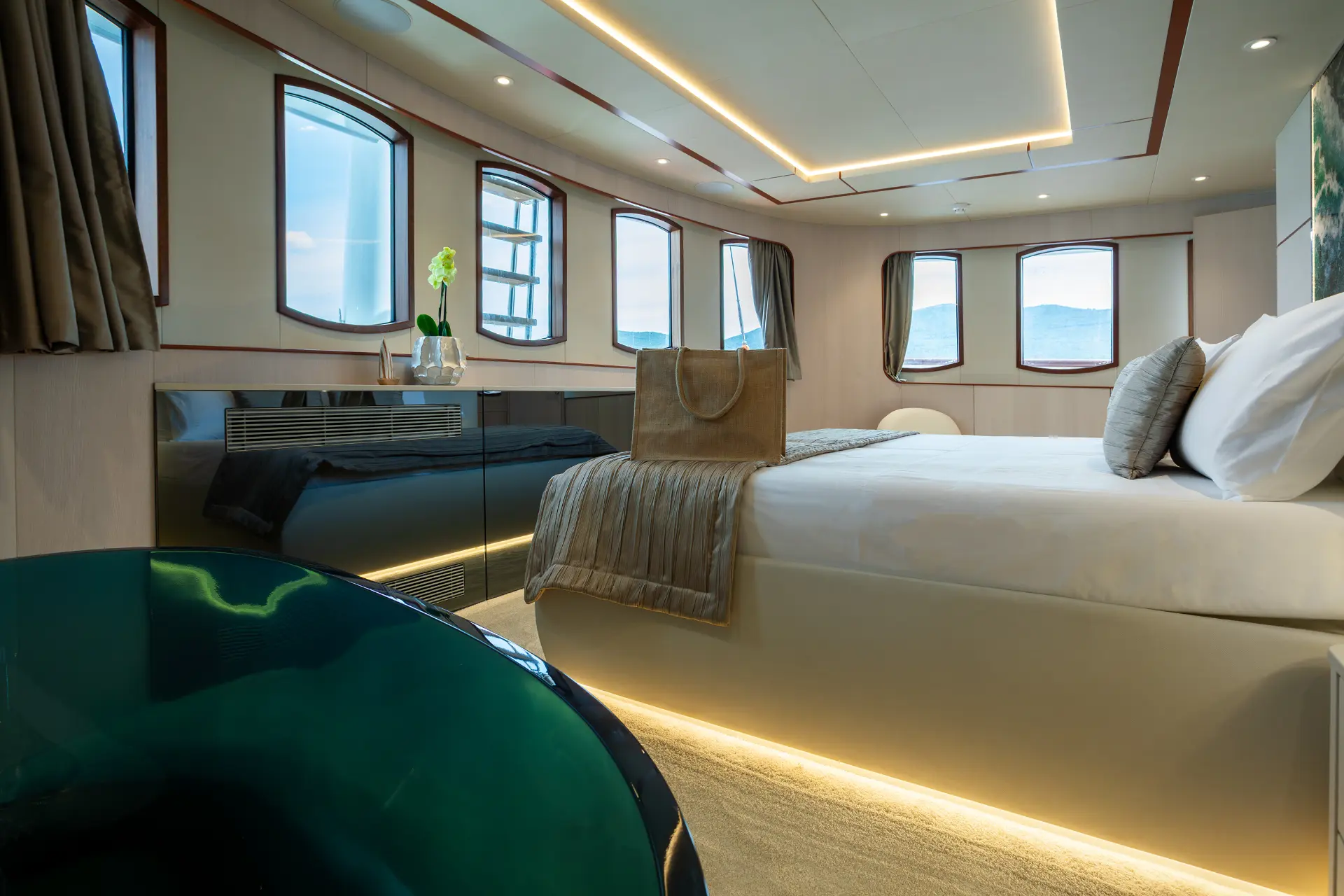 Maia – luxurious double bedroom with ambient lights and decor, view towards stylish windows