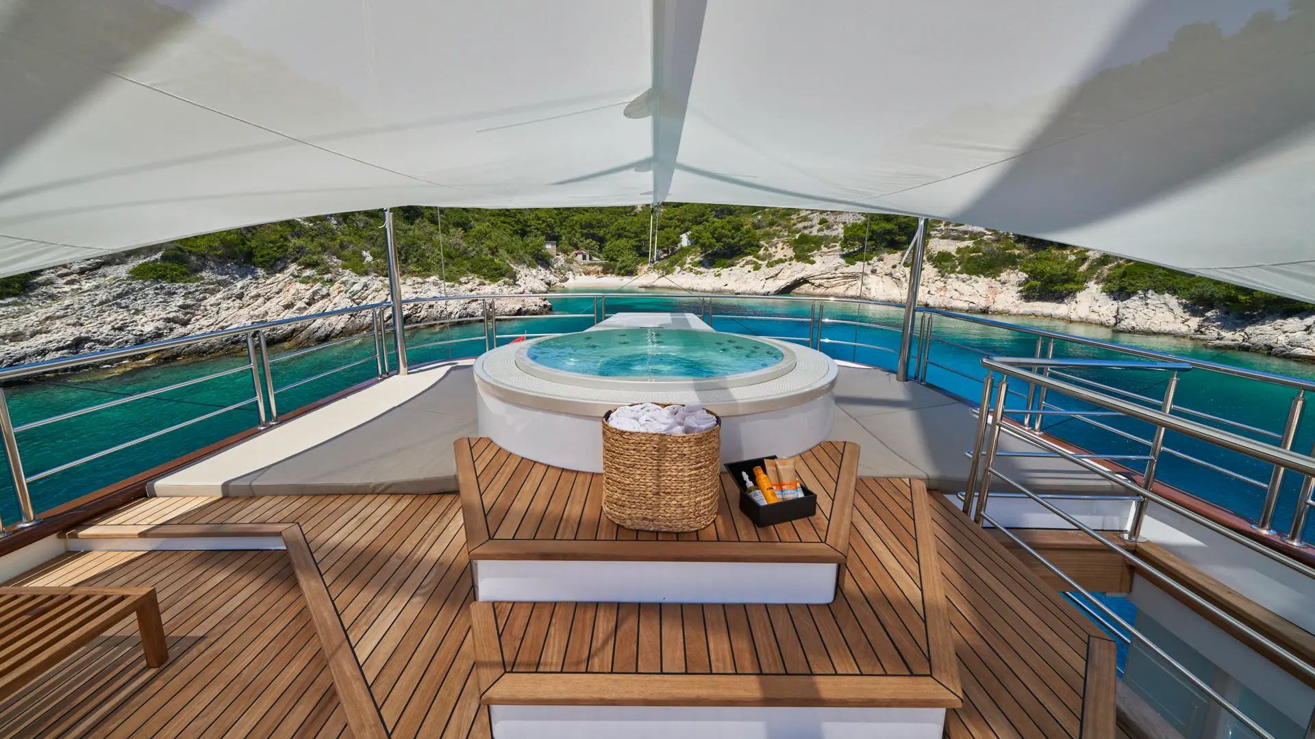 MarAllure – luxury jacuzzi in front, overlooking a stunning scenic coastline under clear skies.