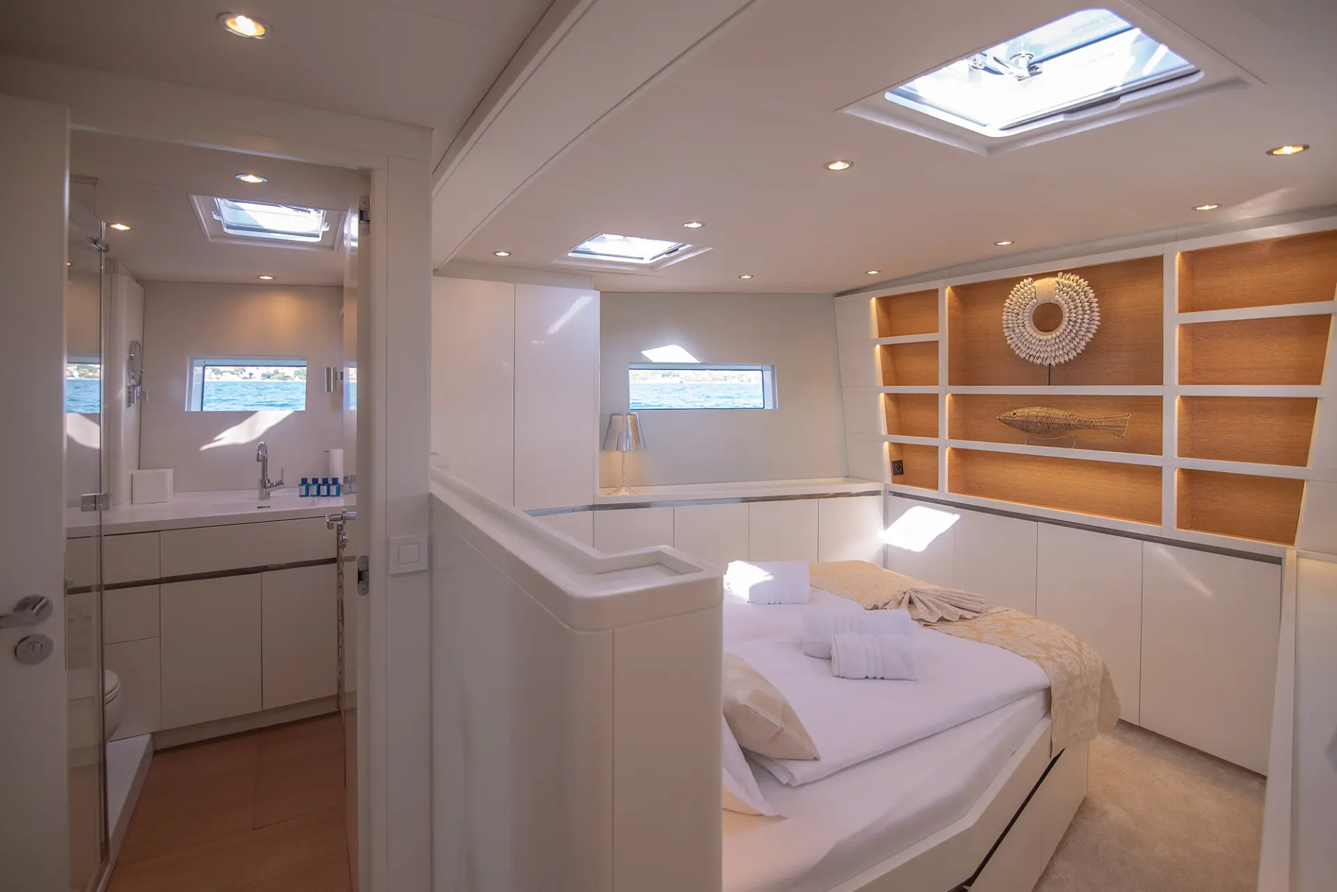 CNB 76 – light-filled cabin featuring bedroom, bathroom, multiple windows, and fish-shaped decoration.