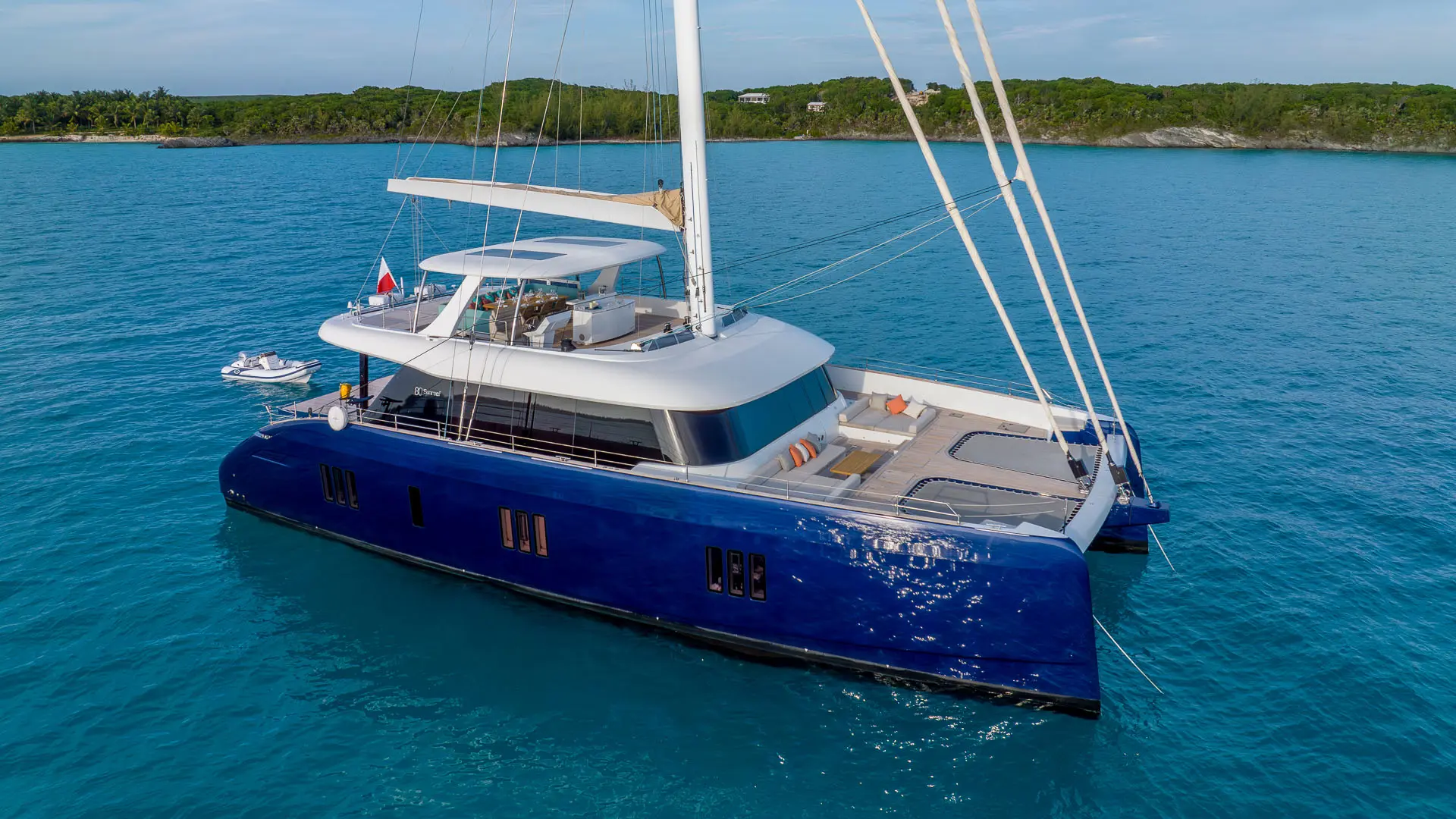 Luxury catamaran Sunreef 80 'Fantastic Too' - sleek side view, blue hull, sun reflecting off the Adriatic Sea.