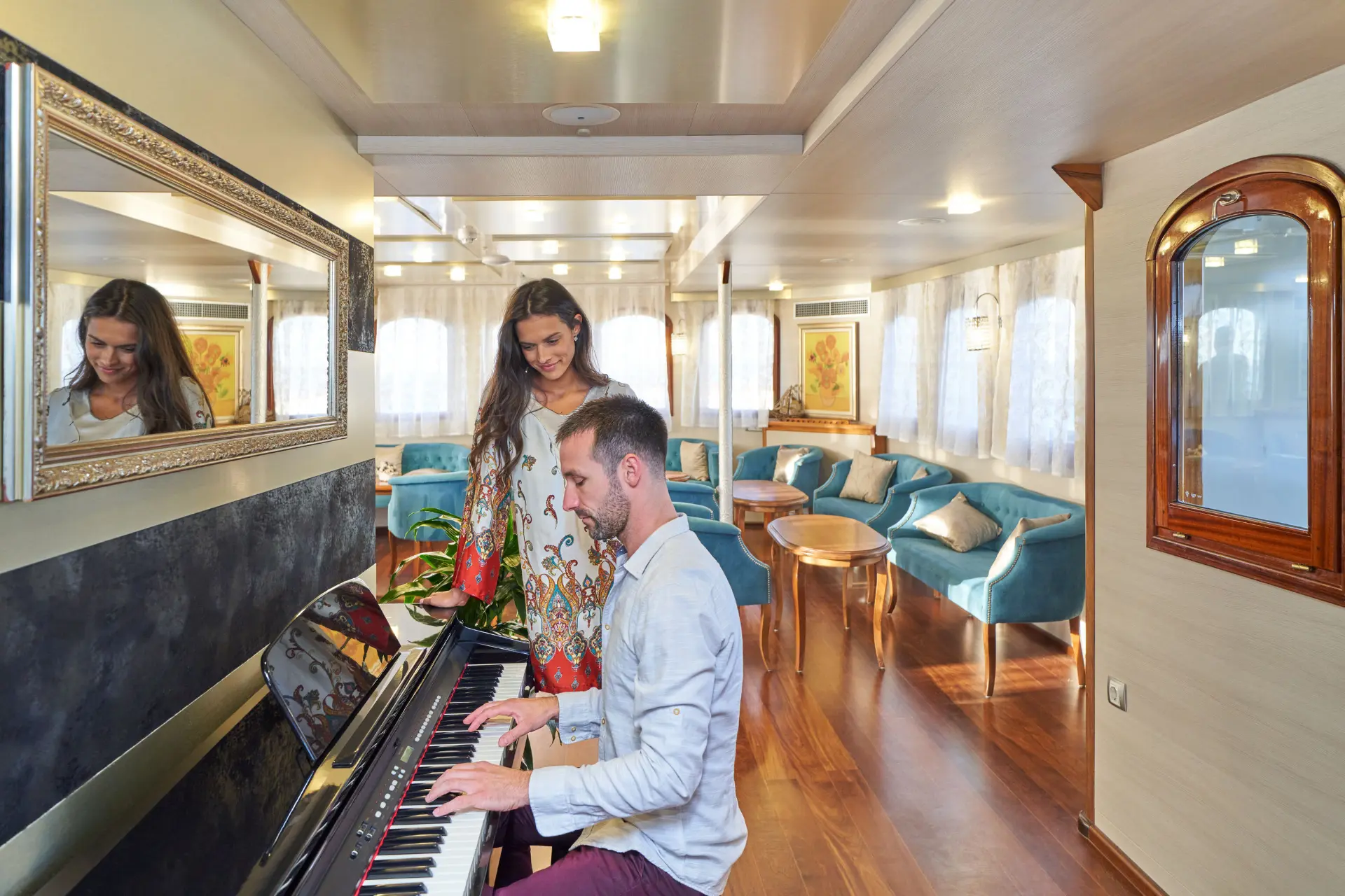 Casablanca - piano performance with woman nearby, sofas and tables in background.