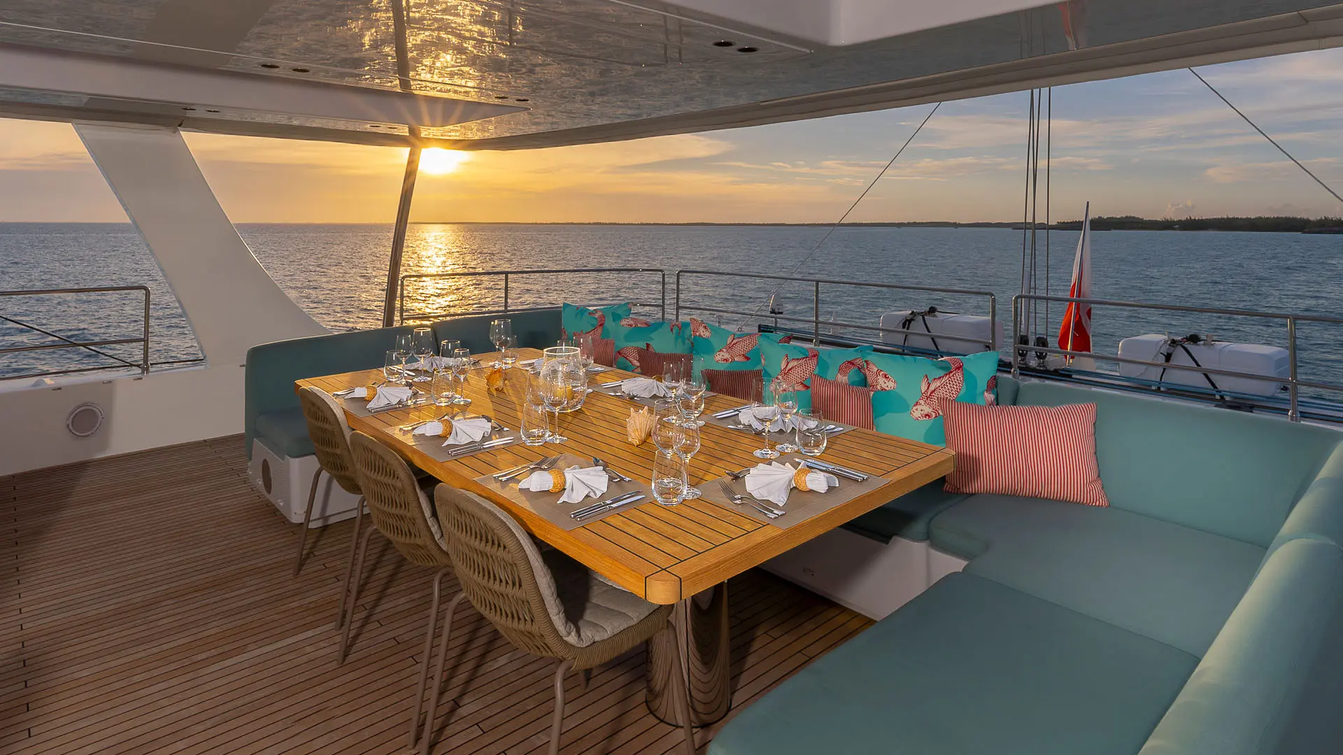 Sunreef 80 'Fantastic Too' - close sunset view of flybridge table prepared for guests.