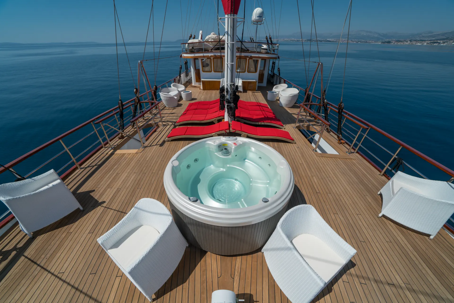 Barbara - foredeck towards aft, 10 red sunbeds, chairs, jacuzzi, panoramic view.