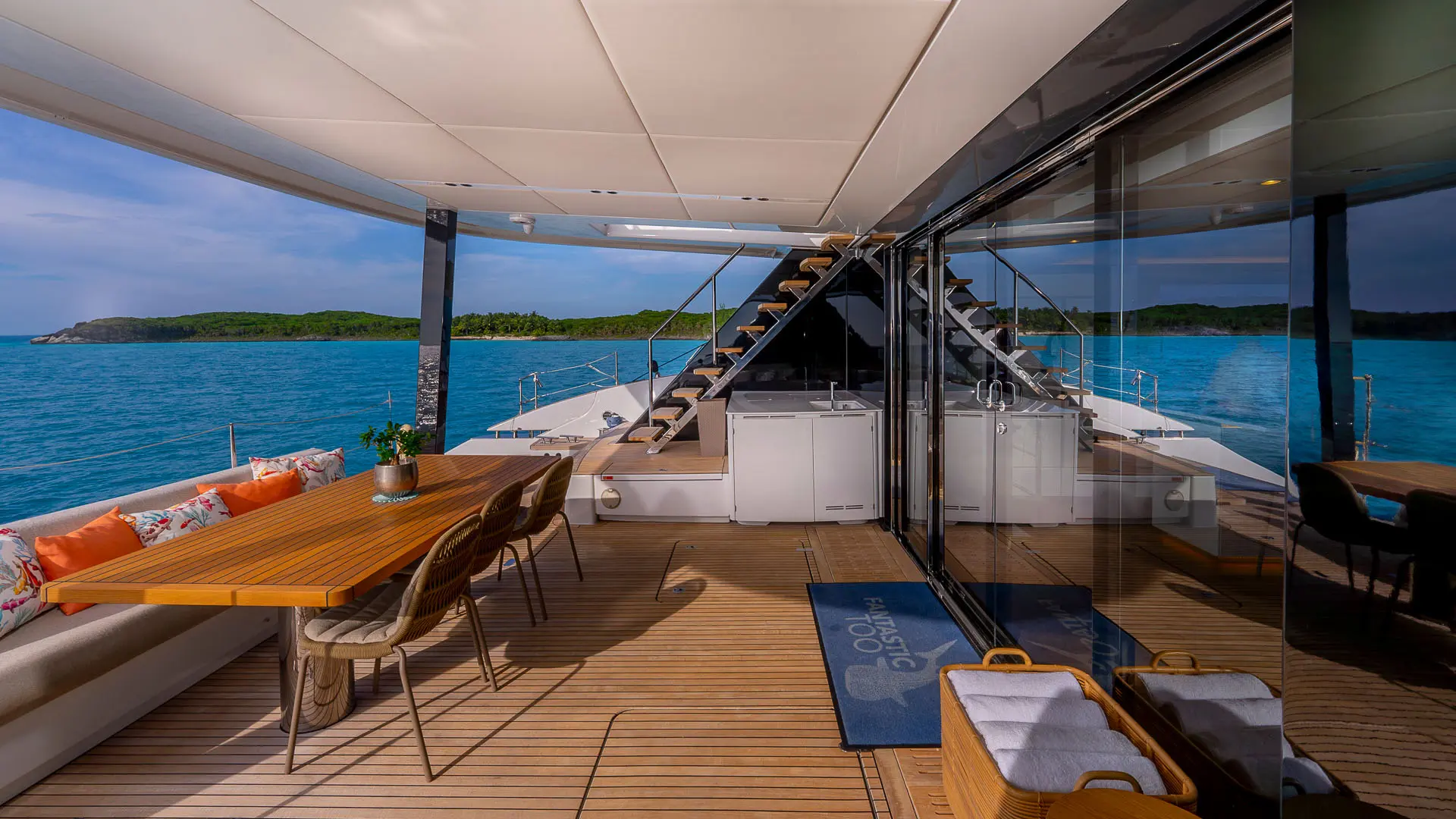 Sunreef 80 'Fantastic Too' - aft cockpit side view, flybridge stairs, dining area, and salon entrance.