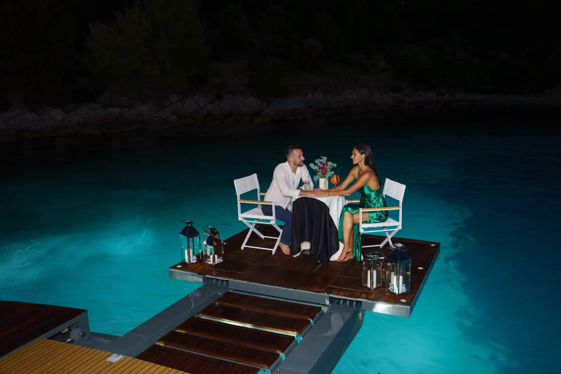 Agape Rose - Romantic night charter experience: Couple having a private dinner on the aft swim platform.