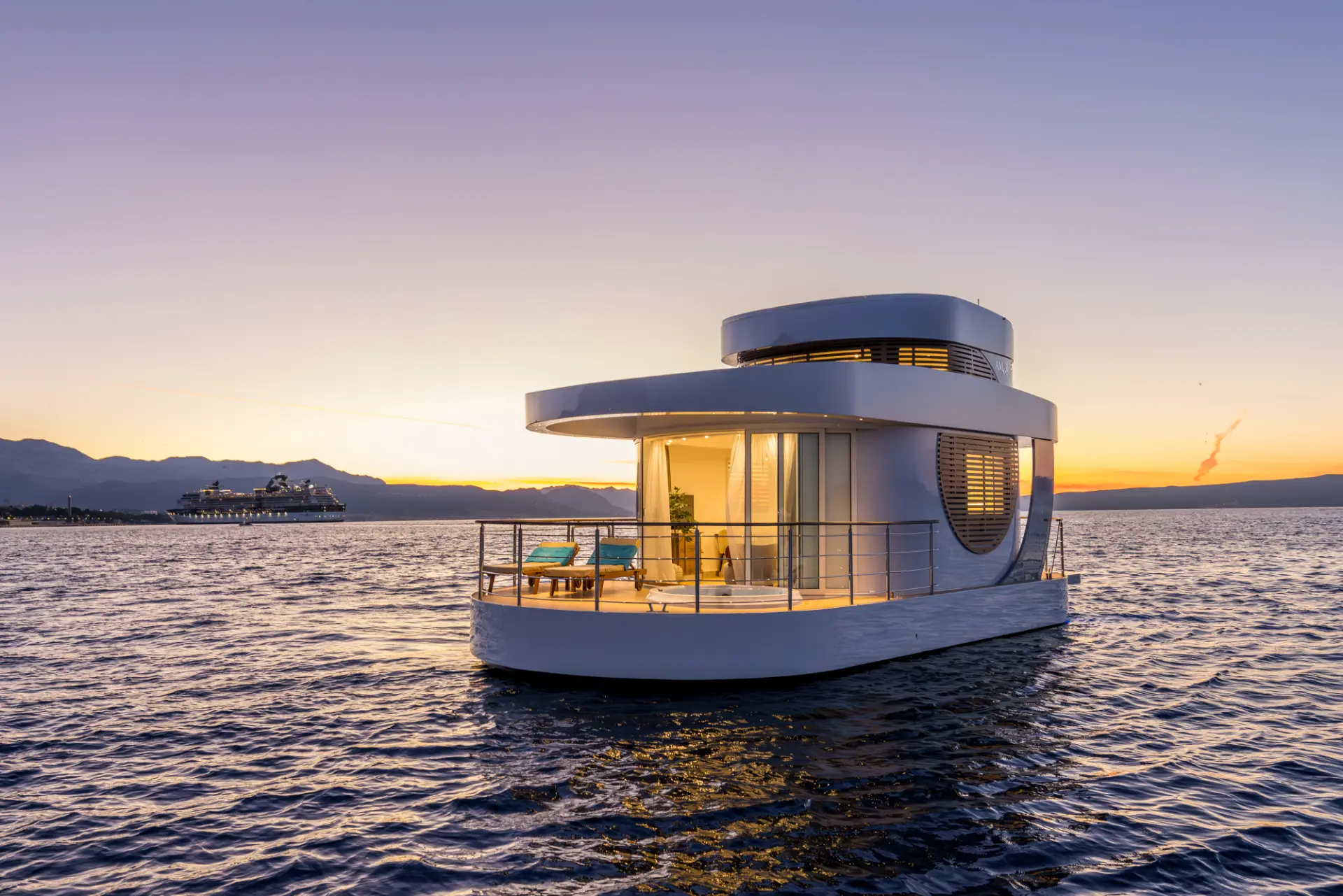 Floating house Amor at sunset, glowing on calm sea waters, offering a unique and peaceful Adriatic escape experience.