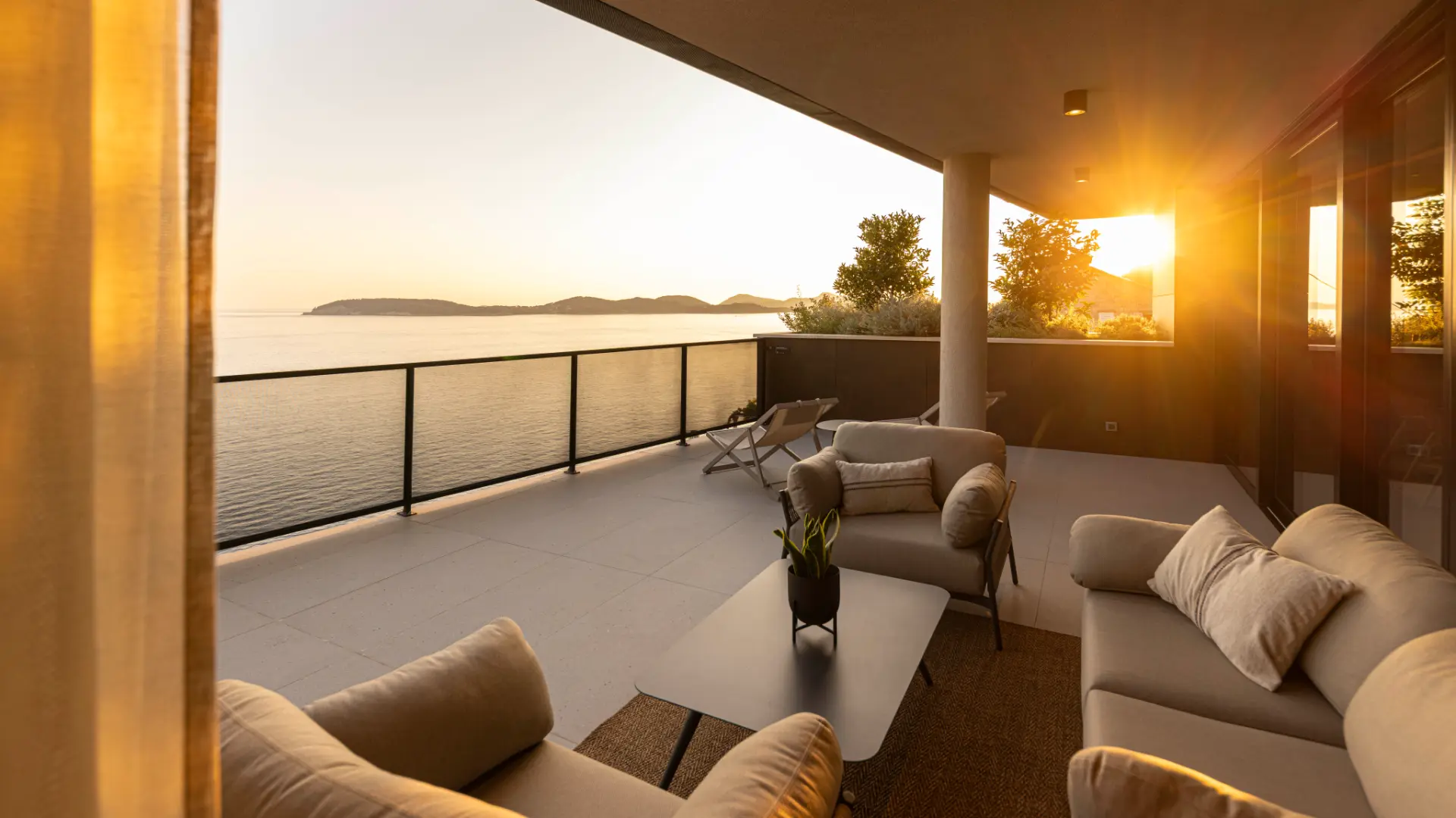Villa Aurea - outdoor terrace with cozy lounge seating, sunset view over Adriatic Sea and island silhouettes